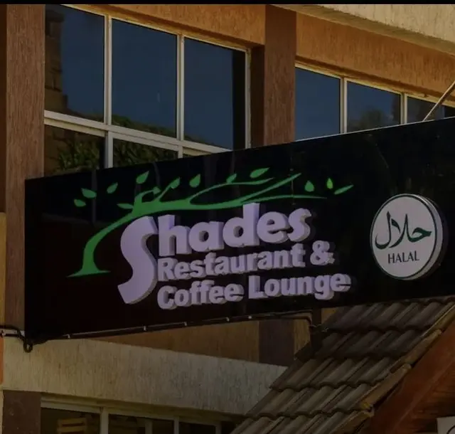 The Shades Restaurant & Coffee Lounge street sign with its halal badge